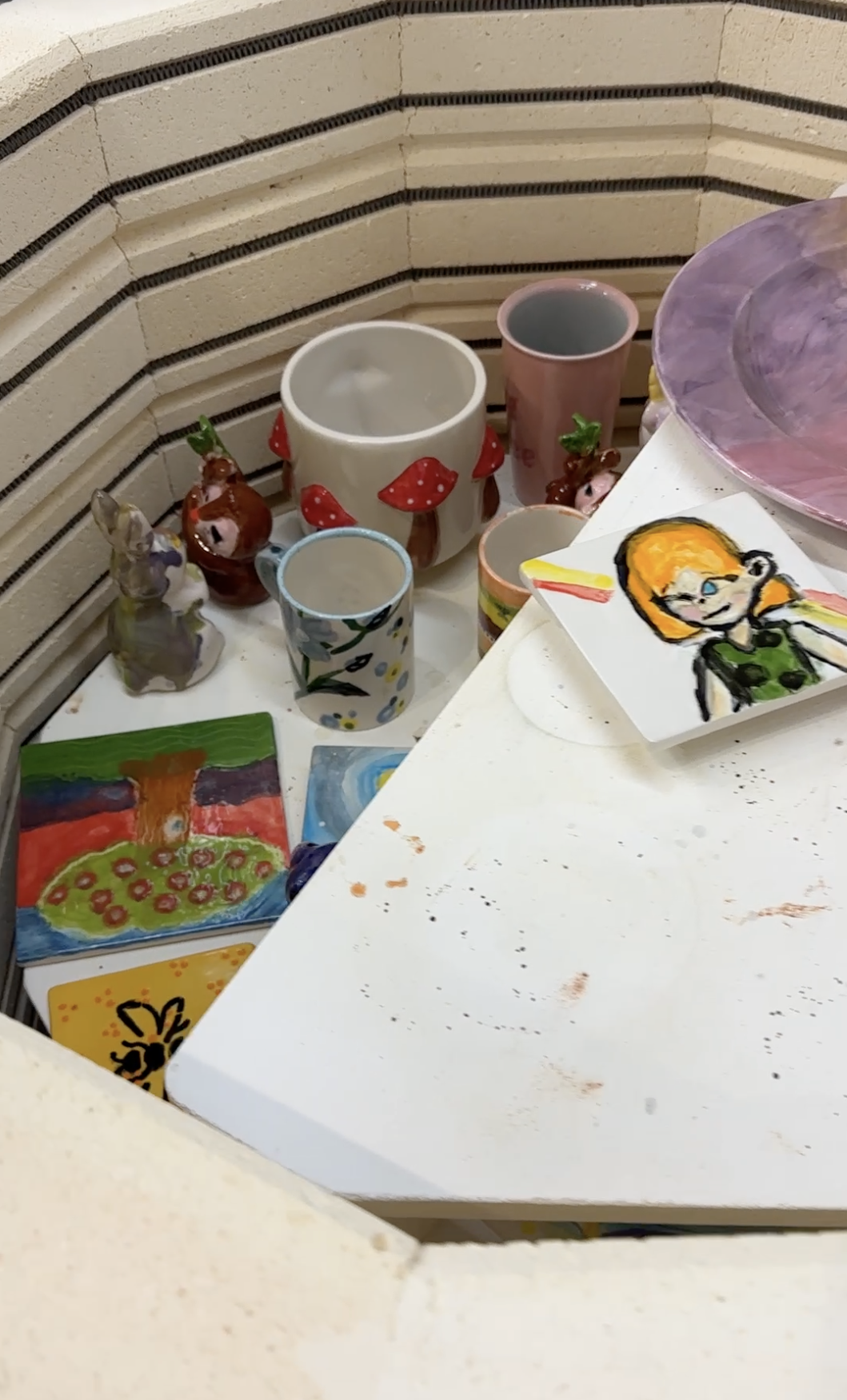 Paint brushes and glaze colors on a table